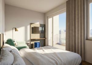 a hotel room with a bed and a large window at Lasalt - Mountain Legends Hotel in Ischgl