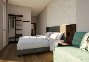a bedroom with a large bed and a couch at Lasalt - Mountain Legends Hotel in Ischgl