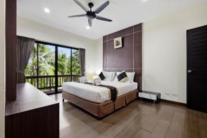 a bedroom with a large bed with a ceiling fan at Rawai Grand House -SHA Plus in Rawai Beach +178 photos