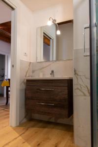 a bathroom with a sink and a mirror at La Stella del Borgo in Castelmezzano