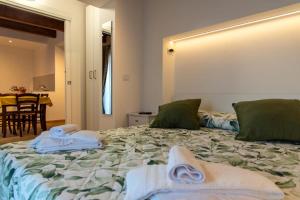 a bedroom with a bed with towels on it at La Stella del Borgo in Castelmezzano