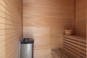 a sauna with a trash can in the corner at Central Stylish Retreat with Sauna in Åre