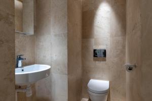 a bathroom with a white toilet and a sink at Central Stylish Retreat with Sauna in Åre