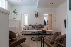 a living room with a couch and a table at Central Stylish Retreat with Sauna in Åre +8 photos