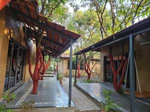 a building with a tree painted on the side of it at Shunyata Eco Resort Junagadh in Vadal