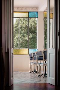 a group of chairs in a room with windows at Ca Meison in Cannobio +248 photos