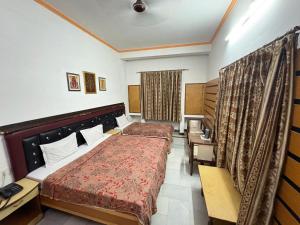 a hotel room with a bed and a desk at Hotel Taj Plaza, Just a 5-minute walk from the Taj Mahal 600 meters in Agra