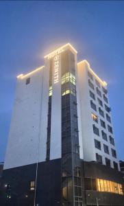 a hotel building with a sign on top of it at 제니스 호텔 in Jecheon