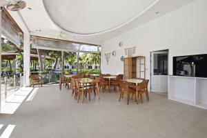 a kitchen and dining room with tables and chairs at Rawai Grand House -SHA Plus in Rawai Beach