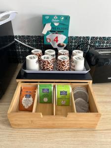 a wooden tray with a box of coffeeaminesamineshiba at Maison tout confort in Corbie