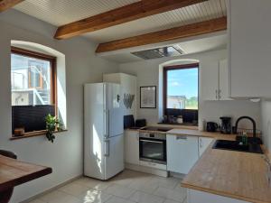 a kitchen with a white refrigerator and a window at Olsson B&B in Randers