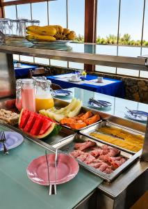 a buffet with different types of food on a table at Pousada Viva Mar in Saquarema