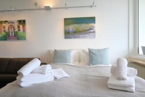 a bedroom with a bed with towels on it at Weber19 - Haus Hammerich in Wenningstedt