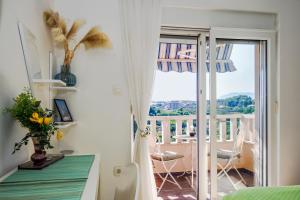 a bedroom with a balcony with a view of a room at SUPER HORIZONT- Sea View Apartments with private Jacuzzi time & Free Parking in Split