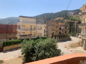 a view of a city street with buildings at Chez NAIM in Tichi