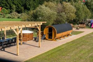 a gazebo and a table and chairs in a yard at Blisko Natury Jacuzzi & Sauna in Pisz