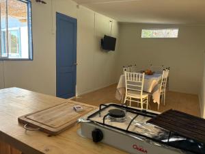 a kitchen with a stove and a table and a dining room at SOL DE LA PALMA in Quillota