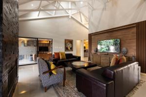 a living room with a couch and a table at Sasavona Cottage - 349 Vaal de Grace Golf Estate in Parys