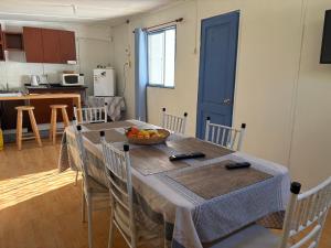 a kitchen with a table with a bowl of fruit on it at SOL DE LA PALMA in Quillota