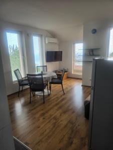 a living room with a table and chairs in it at Seaview apt. 3 complex Karia in Kavarna