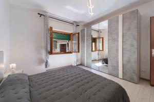 a bedroom with a bed and a large mirror at Casa Margherita in Forno