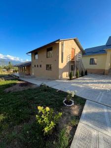 a large house with a patio and a yard at Kaganat village in Uchar
