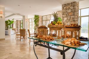 a table filled with lots of different types of bread at Marti La Perla - Adult Only+16 in Marmaris