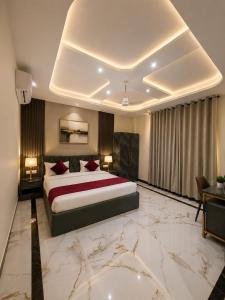 a bedroom with a large bed and a large marble floor at Hotel KS Palace in Varanasi