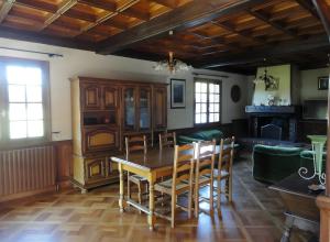 a dining room with a table and chairs at Gite Du Moulin De Veyriat in Lescheroux