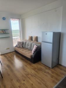 a living room with a couch and a refrigerator at Seaview apt. 3 complex Karia in Kavarna