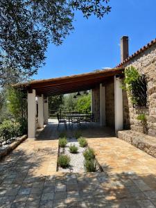 a pavilion with a table and chairs on a patio at Casa La Liccia in Calangianus