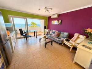 a living room with a couch and a table at Top augestattetes Apartment Monte Rojo in Maspalomas +15 photos