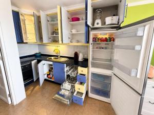 a kitchen with a refrigerator with its doors open at Top augestattetes Apartment Monte Rojo in Maspalomas