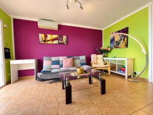 a living room with a couch and a table at Top augestattetes Apartment Monte Rojo in Maspalomas