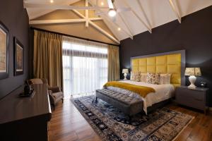 a bedroom with a large bed and a large window at Sasavona Cottage - 349 Vaal de Grace Golf Estate in Parys