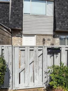 a white wooden gate in front of a house at Town House in Norman