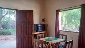 a dining room with a table and a window at Vivir en Maimará in Maimará