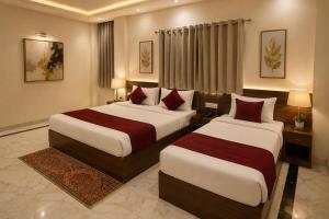 a hotel room with two beds in a room at Hotel KS Palace in Varanasi