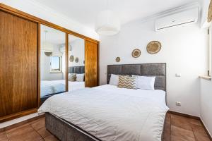 a bedroom with a large bed and a mirror at Villa Sea View Carvoeiro in Carvoeiro +19 photos