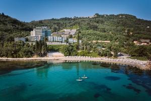 an aerial view of a beach with two boats in the water at Mythos Palace Resort - Adults Only in Boukari