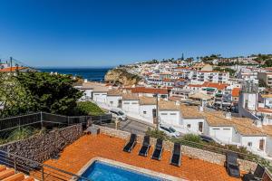 a villa with a swimming pool and a city at Villa Sea View Carvoeiro in Carvoeiro