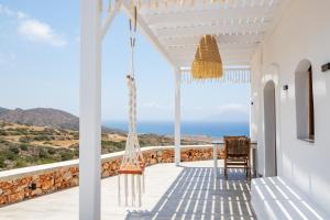 a view of the ocean from the porch of a house at Mythos Villa Above the Sunset in Karpathos