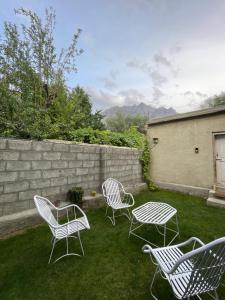 a group of chairs and a table in a yard at Alpen Hotel Skardu in Skardu +31 photos
