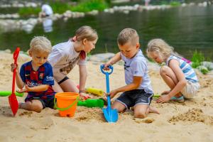 three children playing in the sand on the beach at Hotel Litworowy Staw in Białka Tatrzańska +162 photos