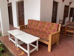 a couch and a coffee table in a room at CAAA Youth Hostel in Kibanguni