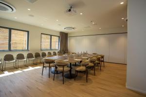a conference room with a long table and chairs at Continental Golf Resort in Verbania