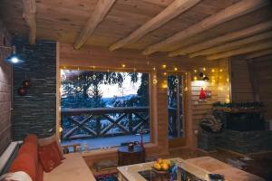 a living room with a large window in a cabin at Vikendica Hills Vlašić in Šišava