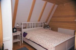 a bedroom with a bed and two night stands at Vikendica Hills Vlašić in Šišava