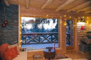 a room with a large window in a cabin at Vikendica Hills Vlašić in Šišava