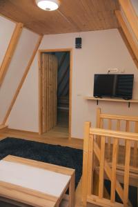 a living room with a flat screen tv on the wall at Vikendica Hills Vlašić in Šišava